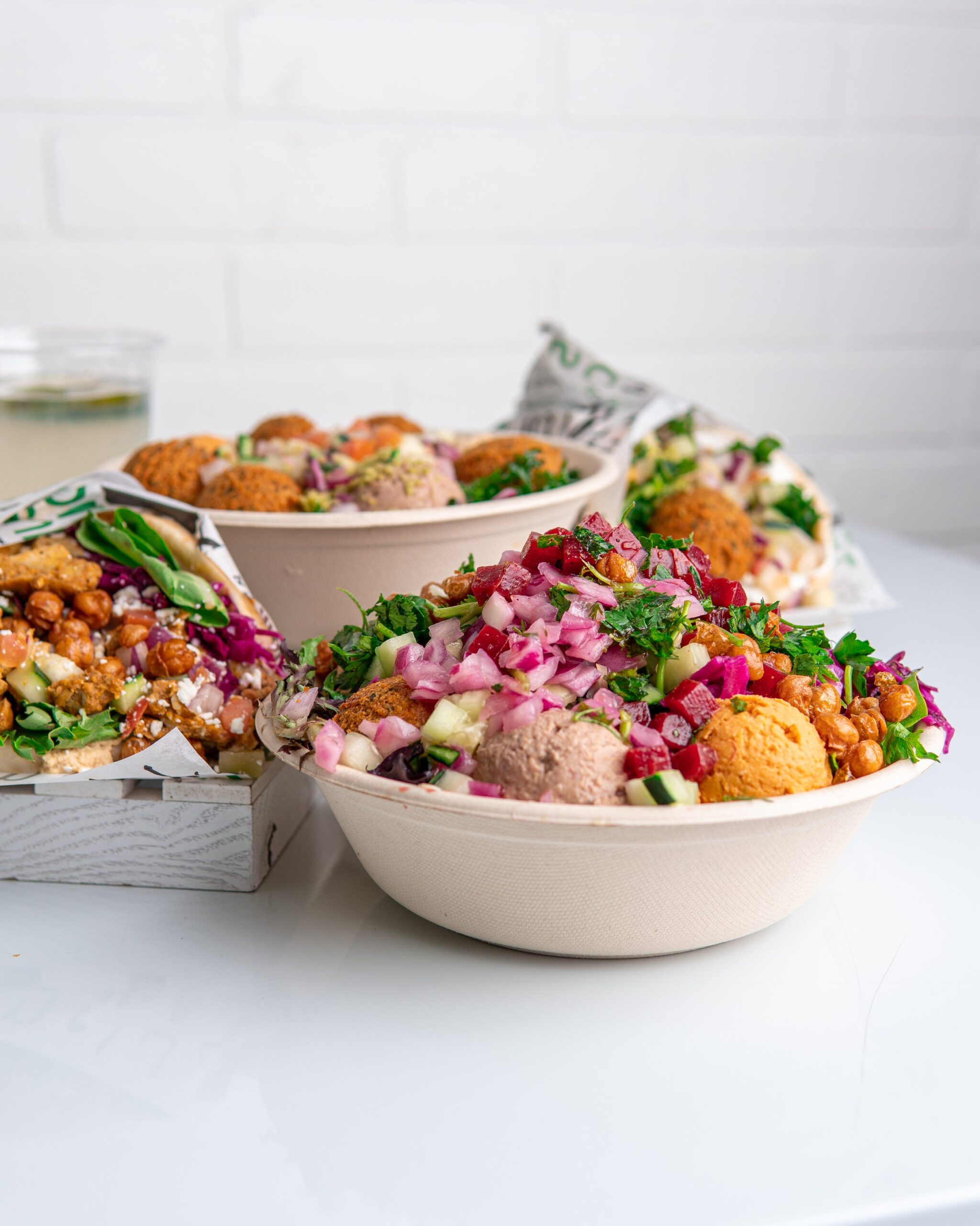 How Owning a Mediterranean Restaurant Lets You Represent Your Community — Not Just Serve It Fresh Mediterranean food displayed at a fast-casual counter inside a franchise with cultural food identity restaurant location, showcasing hummus, shawarma, and falafel under natural light