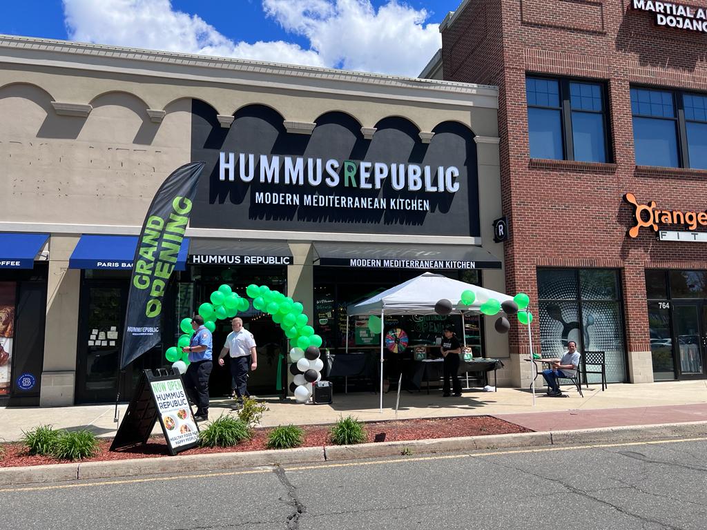 What Actually Happens During Franchise Training — Week by Week A freshly prepped Mediterranean fast-casual counter at a Hummus Republic location showing what to expect at franchise training in terms of food standards and presentation