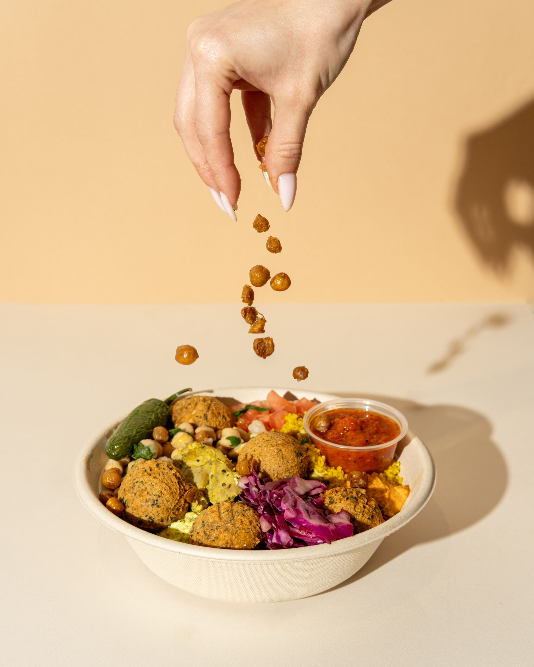 Why a Short, Intentional Menu Builds More Customer Trust Than a Long One Fresh hummus bowls and Mediterranean dishes arranged on a clean fast casual counter, capturing exactly what customers expect from a fast casual restaurant built on real ingredients