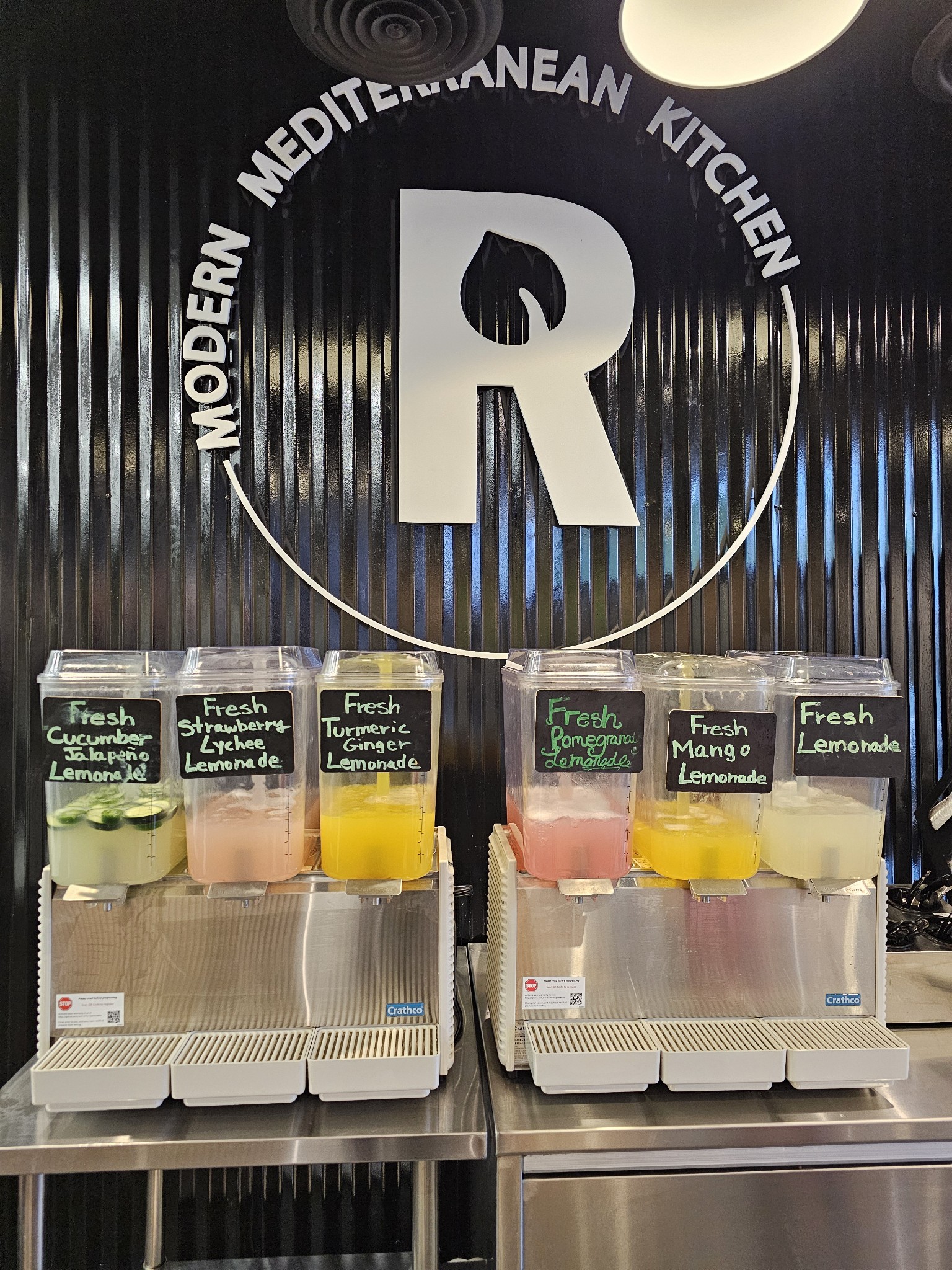 Why Halal Fast Casual Is One of the Most Underserved Markets in America Right Now A franchise for families who want stability location interior showing fresh Mediterranean dishes on a warm wooden counter during a busy lunch service