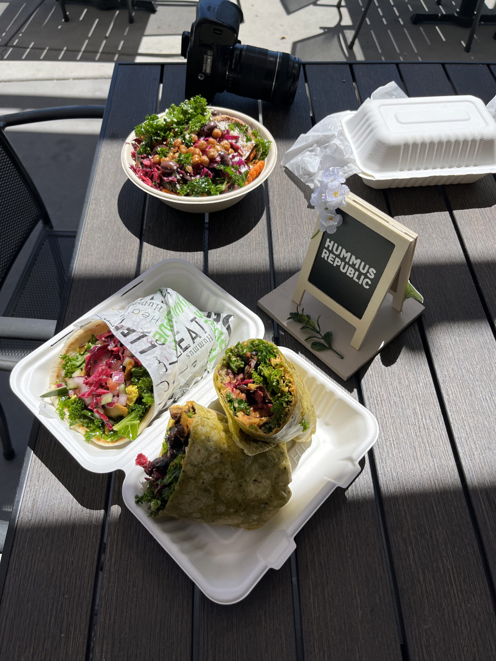 How a Focused Menu Cuts Waste, Lowers Cost, and Keeps Your Kitchen Sane Fresh Mediterranean ingredients arranged at a fast casual counter showing how to reduce waste with a focused menu at Hummus Republic